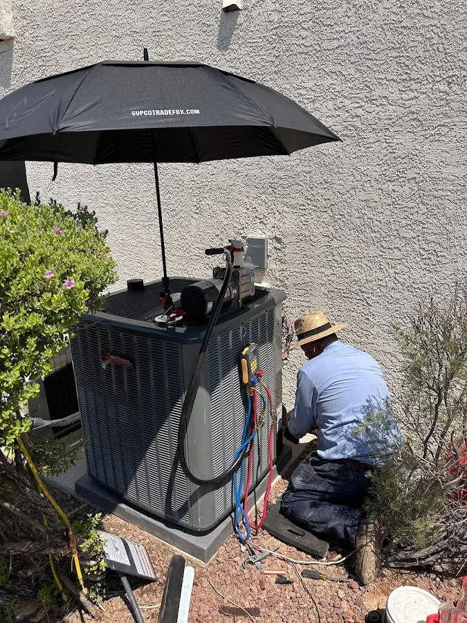 HVAC technician performing outdoor AC maintenance in Gulf Breeze